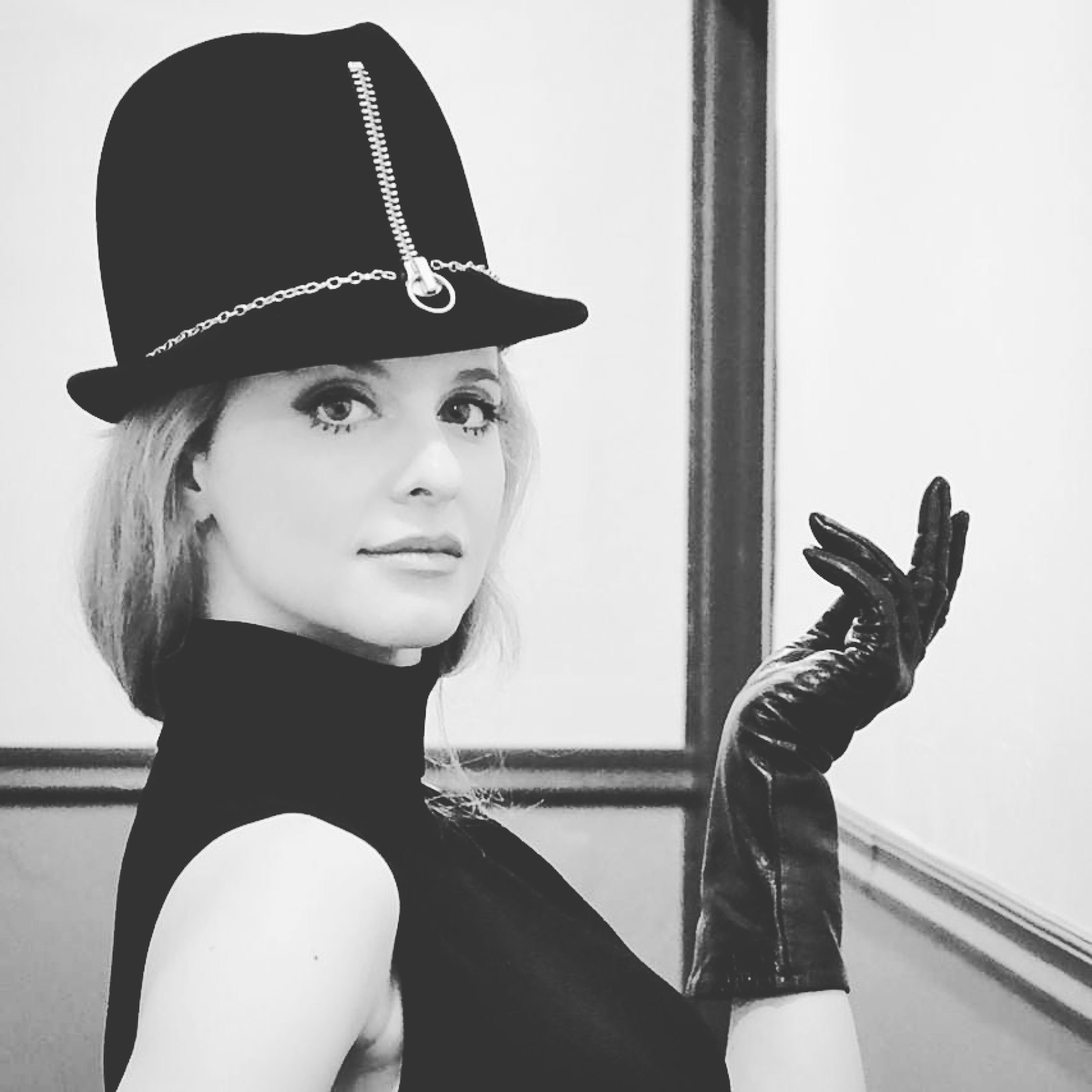 Black and white portrait in a zipper-trimmed hat and long gloves