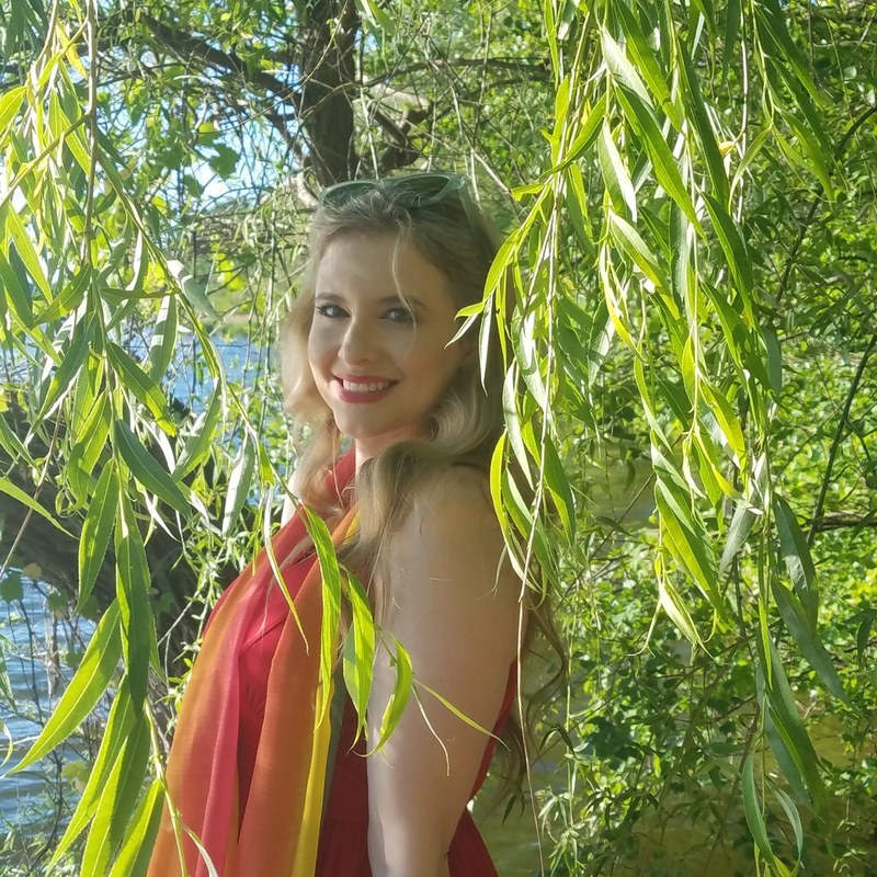 Jenilyn beneath willow branches by the water